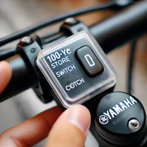 ヤマハ製の電動自転車スイッチに透明な100均のスイッチカバーが装着されている。